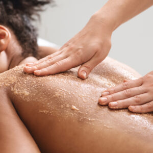 Woman having a Exfoliating Back Scrub as an Add On treatment to Lymphatic Drainage