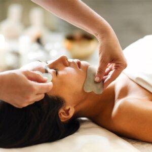 Woman receiving a Gua Sha Facial Add on Treatment to Lymphatic Drainage