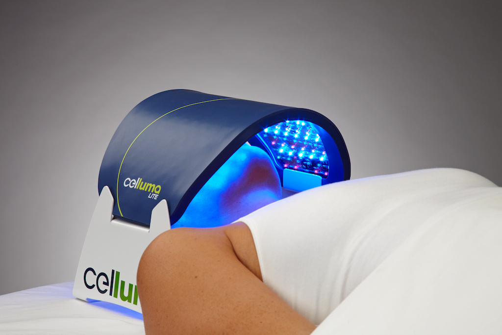 Celluma LITE LED Light Therapy Device completing facial treatment on patient