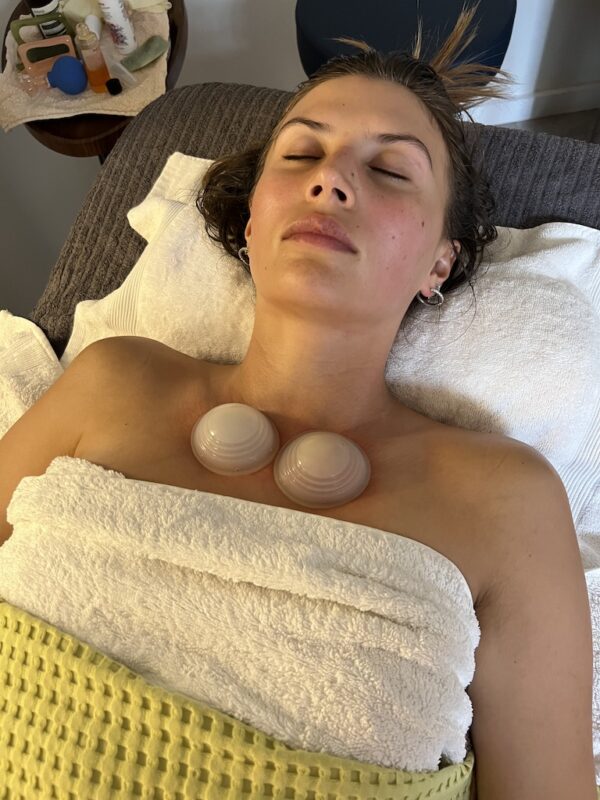 Female Client receiving the cupping part of a Buccal Release Massage 